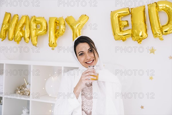 Eid al fitr concept with woman drinking tea