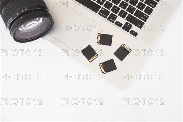 Elevated view dslr camera memory cards laptop keyboard