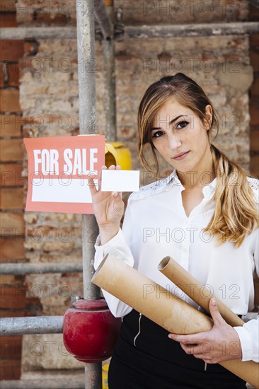 Female real estate agent showing business card