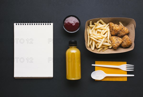 Flat lay assortment with fries notebook