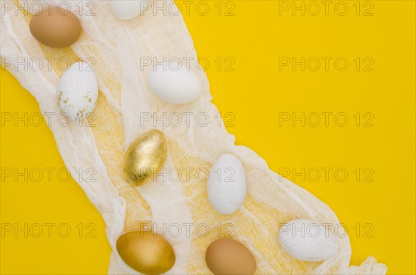 Flat lay eggs easter with gold paint textile