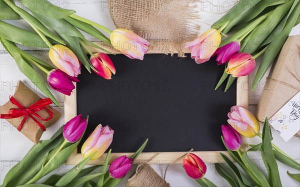 Frame chalkboard decorated by tulips gift boxes