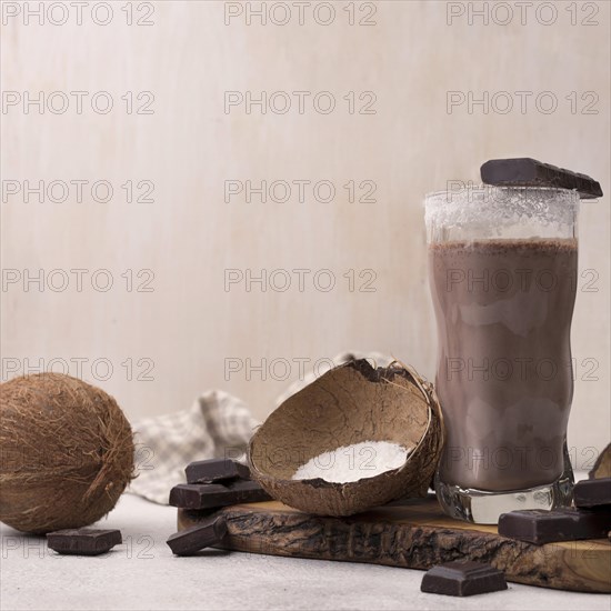 Front view chocolate coconut milkshake glass with copy space