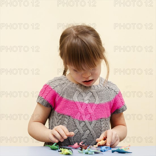 Front view girl with down syndrome toys