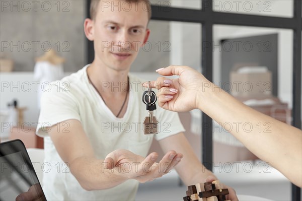 Front view man accepting keys new house