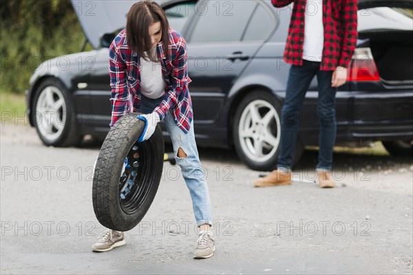Front view woman holding tire