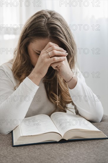 Front view woman praying home