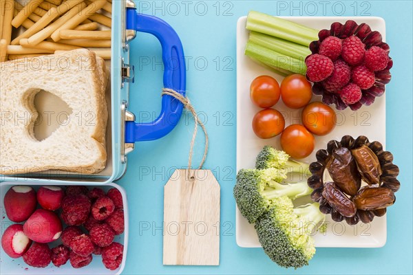 Fruits vegetables near nice lunchbox