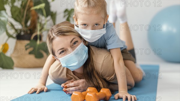 Full shot boy woman wearing masks