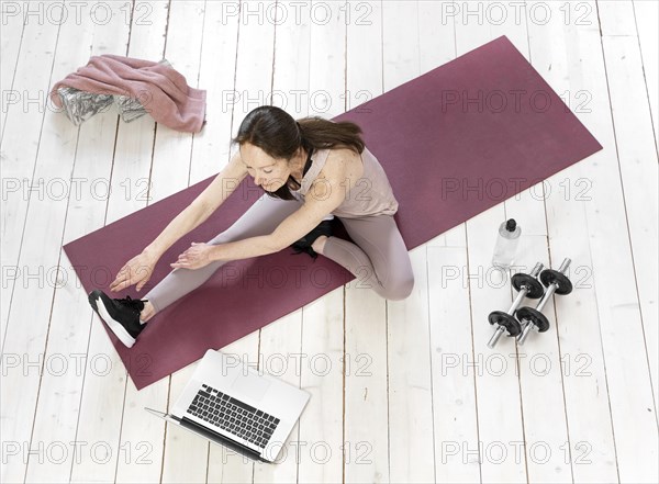 Full shot senior woman stretching