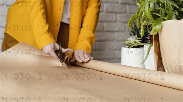 Gardener cutting some wrapping paper