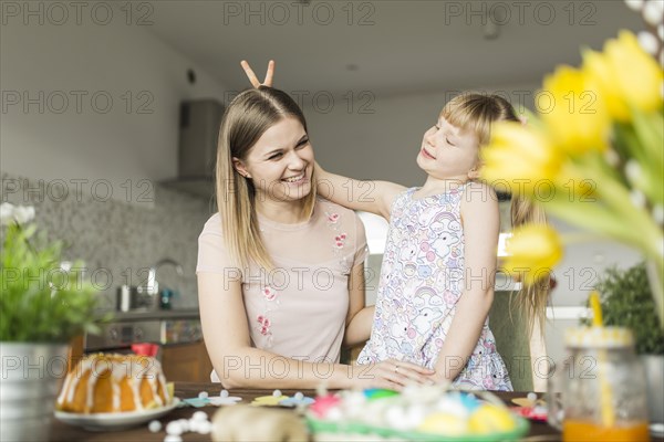 Girl gesturing horns mother