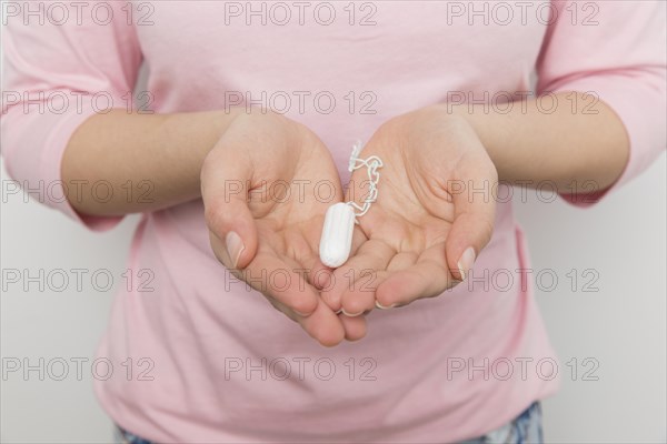 Girl holding clean tampon