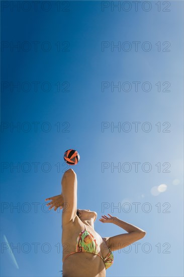Girl playing volleyball sunny day
