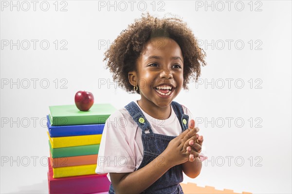 Girl with books laughing studio