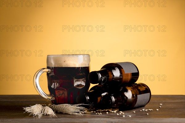 Glass beer with foam bottles beer wooden table