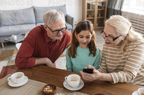 Grandparents girl looking phone
