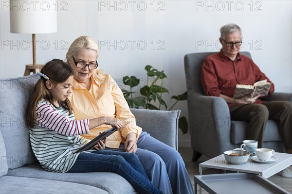 Grandparents girl with laptop inside