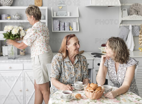 Granny grand daughter talking with each other while having breakfast