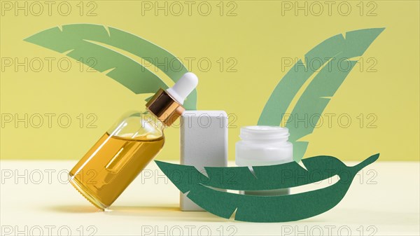 Green leaves with serum bottle