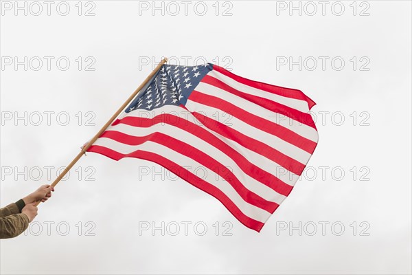 Hands waving american flag