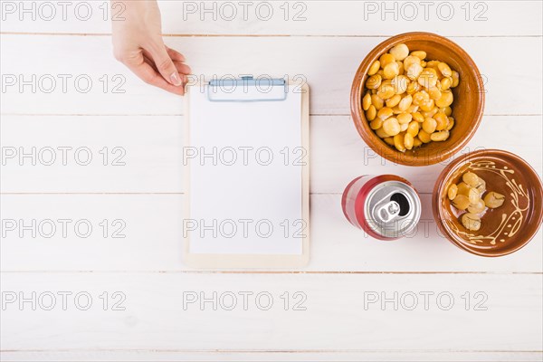 Hand with clipboard bean snack table