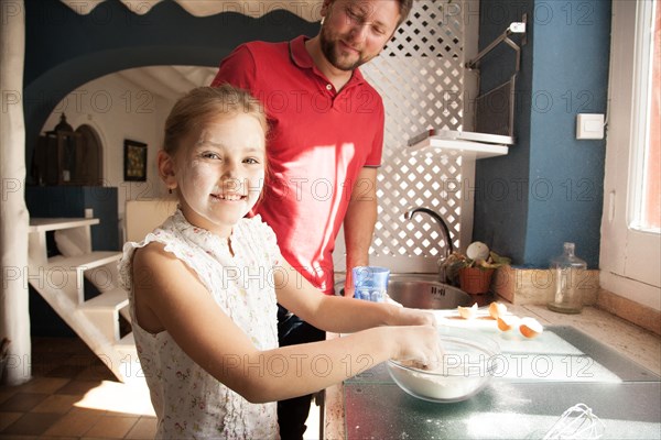 Happy girl with face covered flour