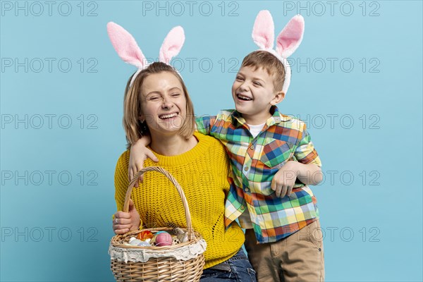 Happy mother son with basket painted eggs