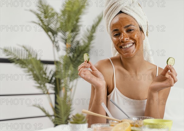 Happy woman using natural face mask