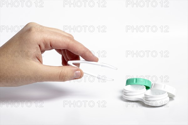 High angle hand holding tweezers contact lenses