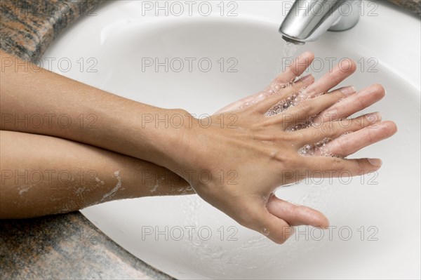 High angle person washing hands