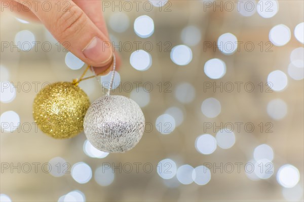 Human hand holding ornament baubles