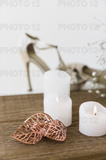 Illuminated white candles wooden table