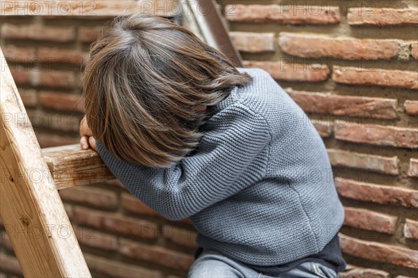 Little boy outdoors upset