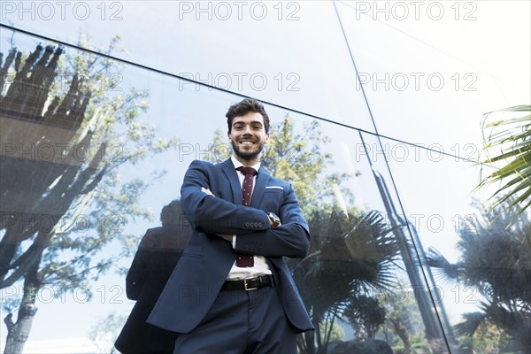 Low angle smiley lawyer posing outdoors
