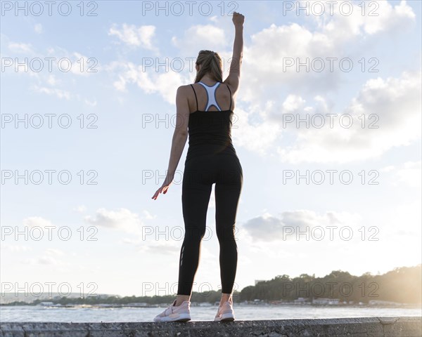 Low angle woman standing victorious way