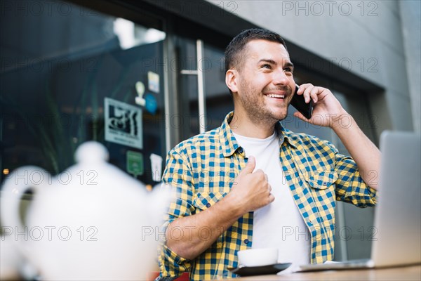Man emotionally speaking phone cafe