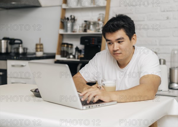 Man home during pandemic using laptop