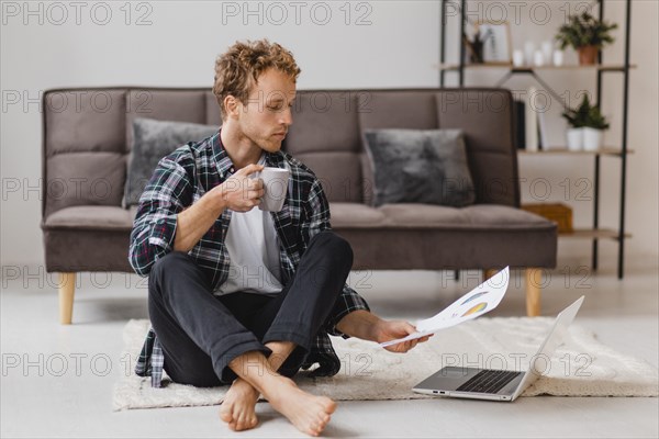 Man planning redecorating house while having coffee