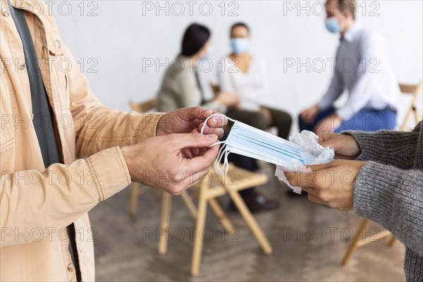 Man receiving medical mask group therapy session