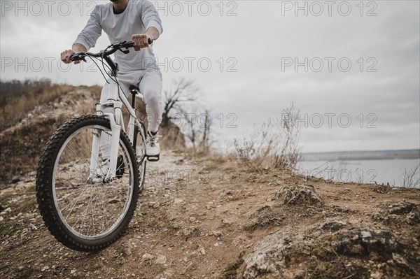 Man riding bike outdoors with copy space