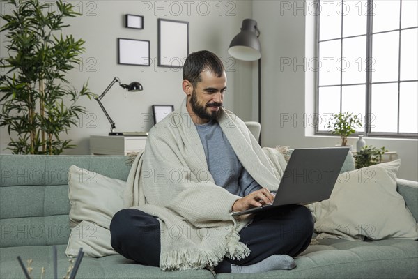 Man sofa working laptop