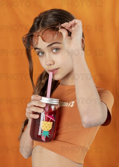 Medium shot girl posing with drink