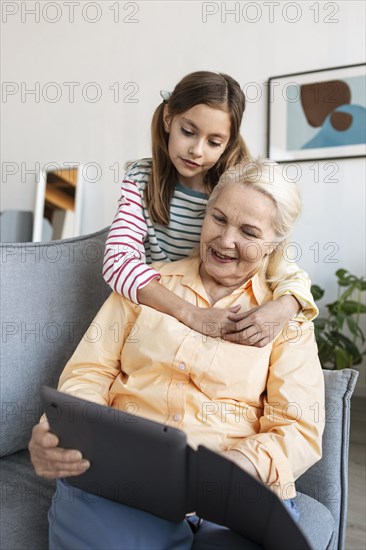 Medium shot granddaughter hugging woman