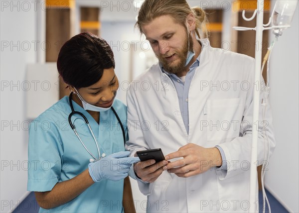 Medium shot health workers with smartphone