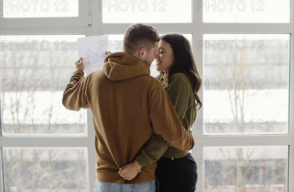 Medium shot romantic couple indoors