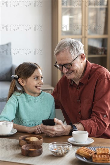 Medium shot smiley grandpa girl