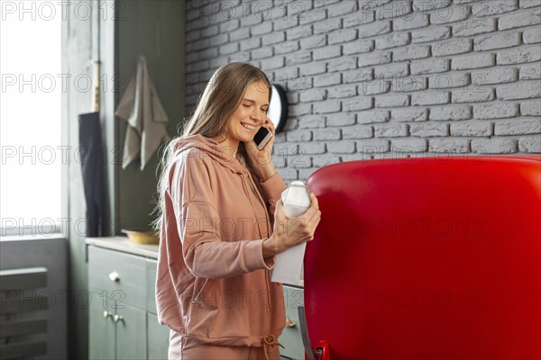 Medium shot smiley woman talking phone