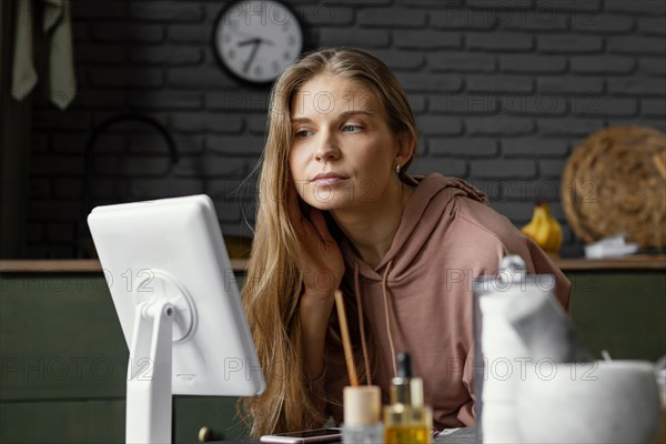 Medium shot woman looking mirror