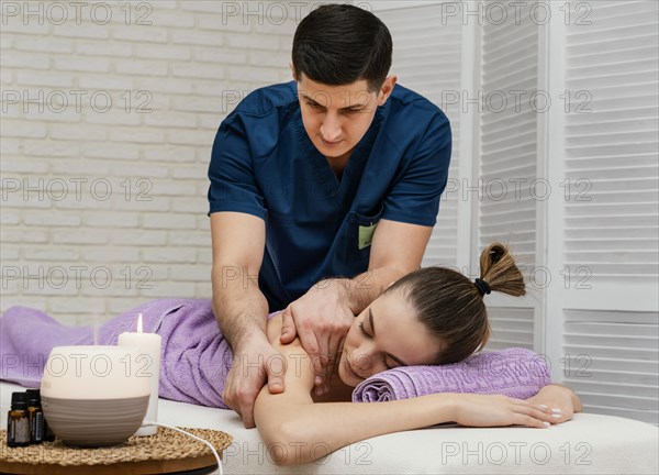 Medium shot woman receiving massage